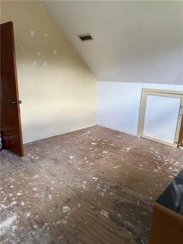Additional living space featuring lofted ceiling