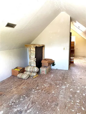 Bonus room featuring vaulted ceiling and a textured ceiling