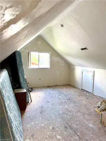 Additional living space featuring vaulted ceiling