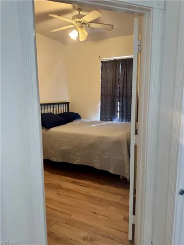 Bedroom with light wood-type flooring and a ceiling fan