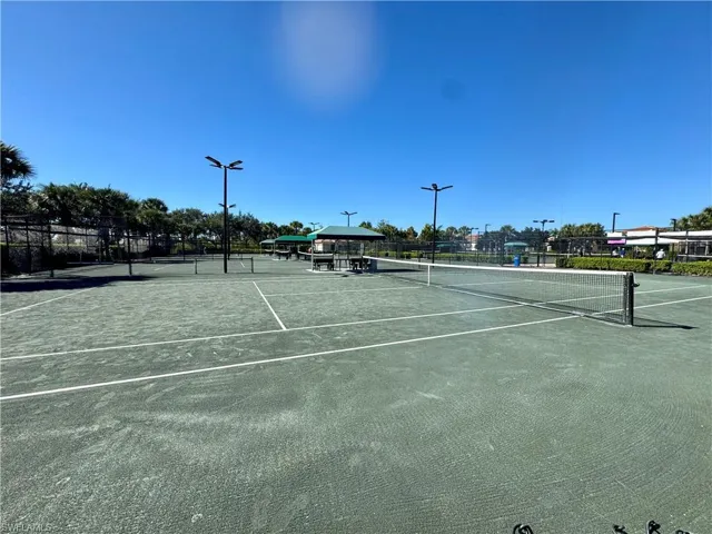 View of tennis court featuring community basketball court