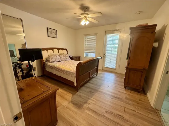 Bedroom featuring light wood-style floors, ceiling fan, and access to exterior