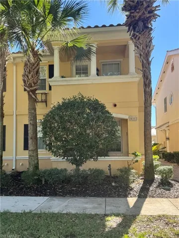 View of front of property featuring a balcony and stucco siding