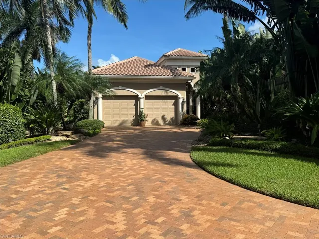 Mediterranean / spanish-style house with a garage