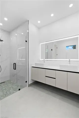 Dual vessel sinks set on a floating vanity with a quartz countertop