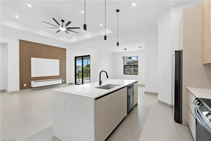 Spacious kitchen island with a white speckled countertop and integrated sink