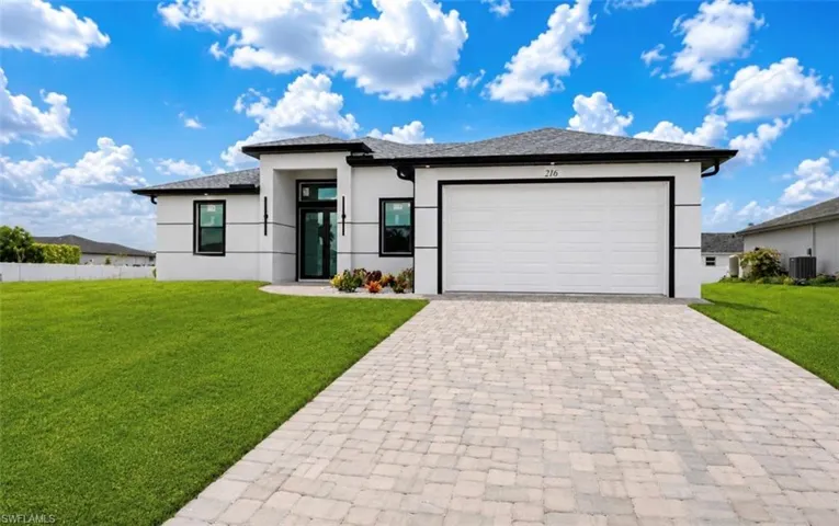 Contemporary single-story residence with a white stucco facade and dark trim accents