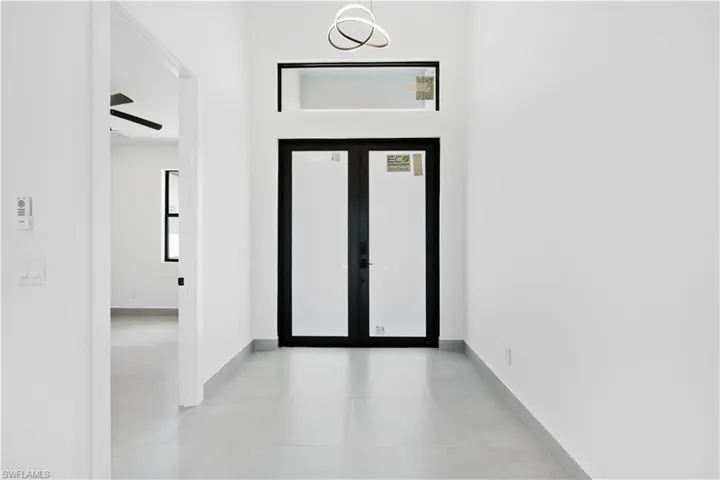 Double entry doors with black framing and frosted glass panels