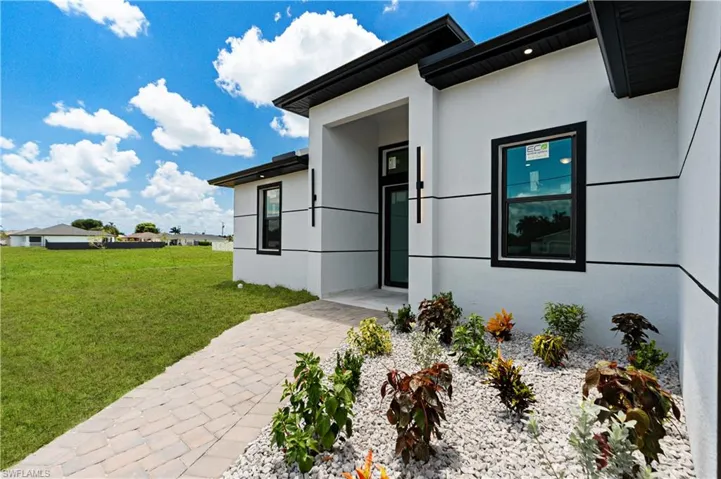 Contemporary stucco exterior with black trim windows