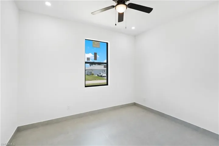 Room featuring a black-framed window, ceiling fan, and recessed lighting