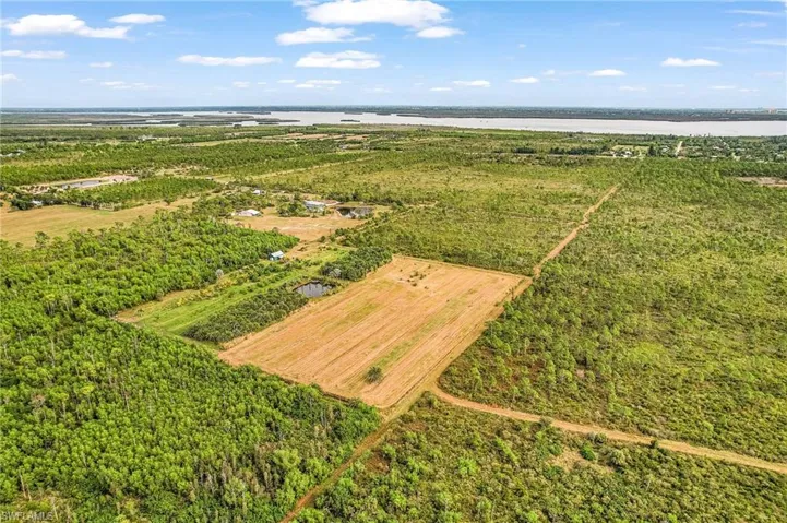 Aerial overview of property's location with a large body of water