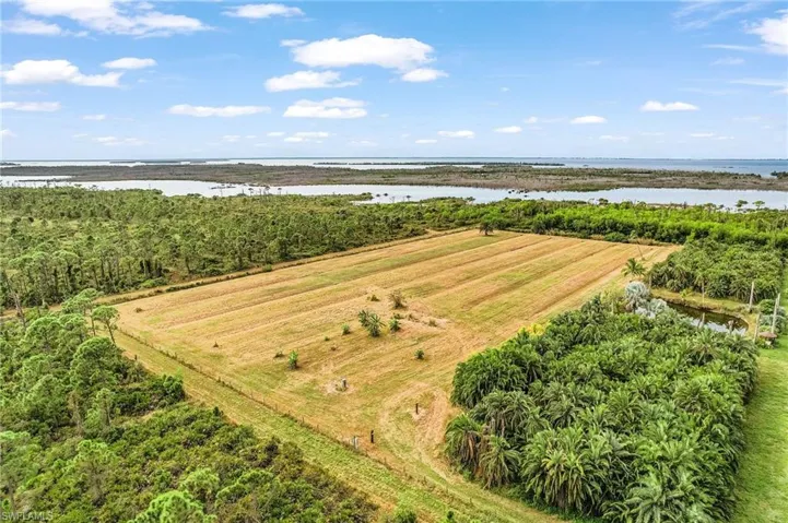 View of rural area with a large body of water and extensive farmland