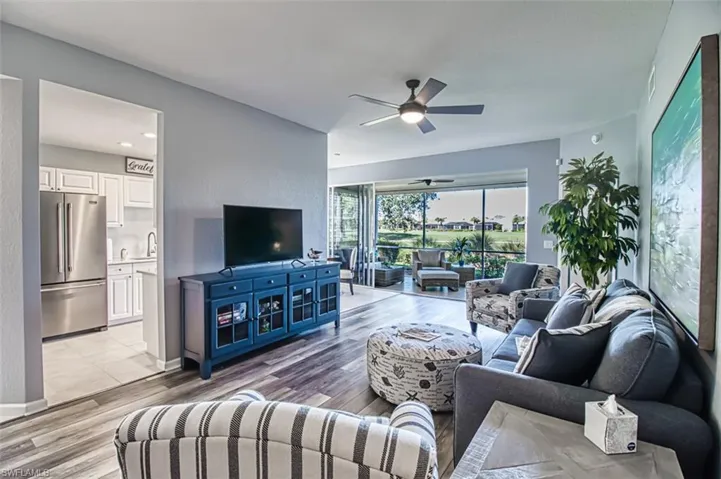 Living room featuring light wood finished floors, ceiling fan, and baseboards