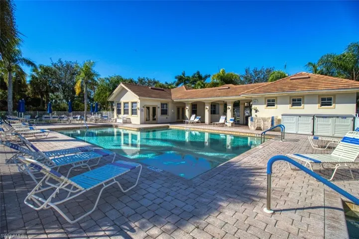 Pool with a patio and fence