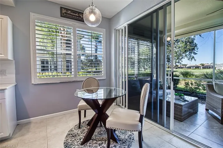 Dining area featuring light tile patterned floors and baseboards