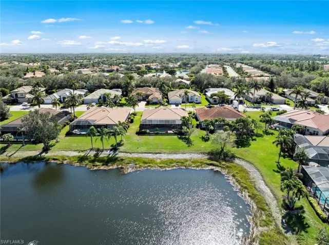 Aerial view over lake looking at rear of home