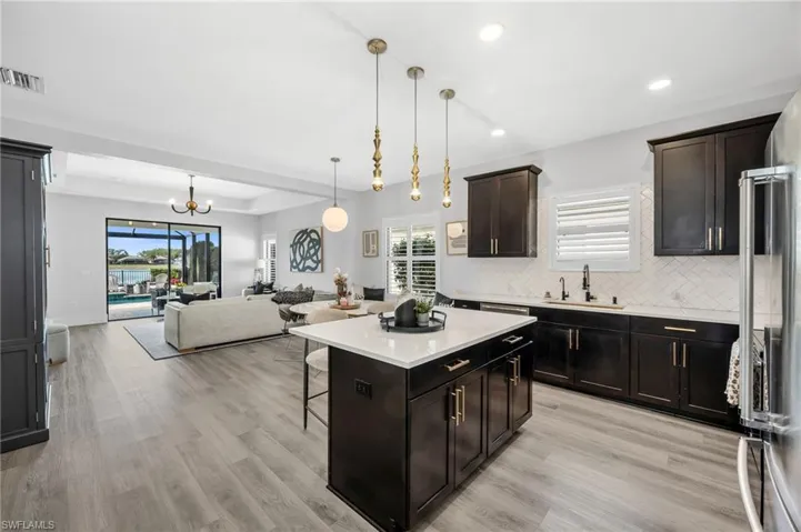 Kitchen Featuring an Island. Open to The Dining Area and Living Room