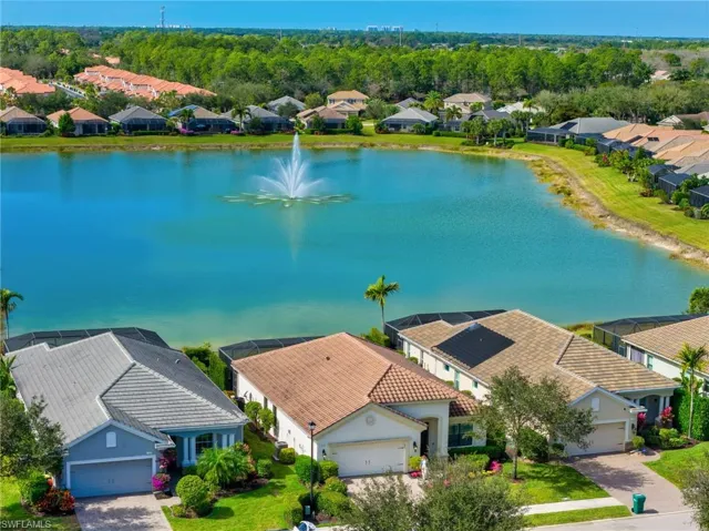 Aerial View of House Featuring Lake with Fountain