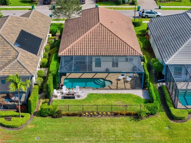 Aerial View Back of House Featuring Fire Pit and Fenced in Backyard
