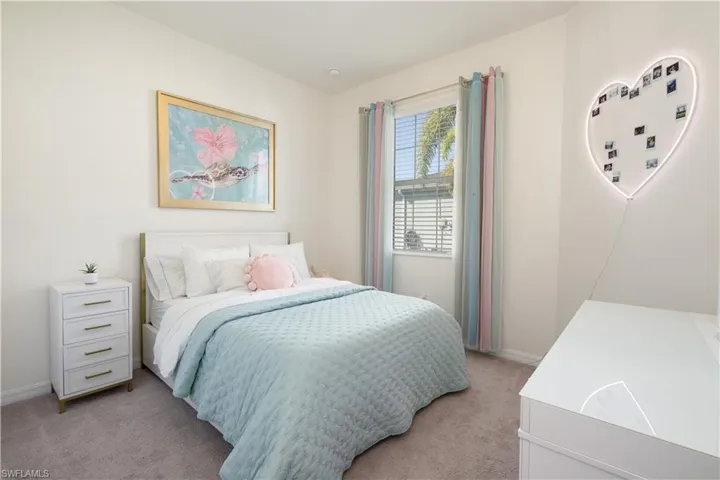 2nd Bedroom featuring light colored carpet