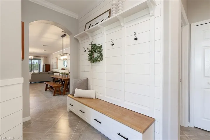Mudroom sytle custom wood entryway foyer area, crown molding and tile flooring