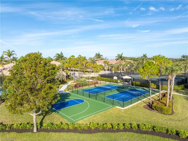 View of basketball court featuring a yard and tennis court