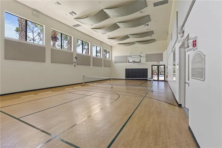 View of basketball court featuring plenty of natural light and tennis court