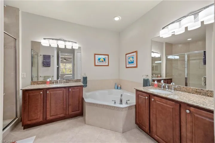 Bathroom featuring vanity, separate shower and tub, and tile patterned floors