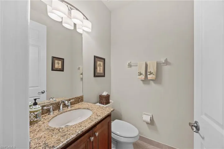 Bathroom featuring vanity, tile patterned floors, and toilet