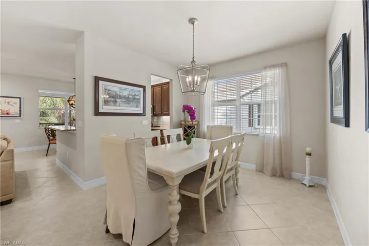 Dining area with an inviting chandelier and light tile patterned floors