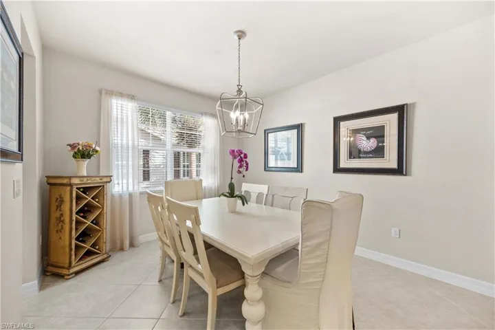 Tiled dining room featuring a chandelier