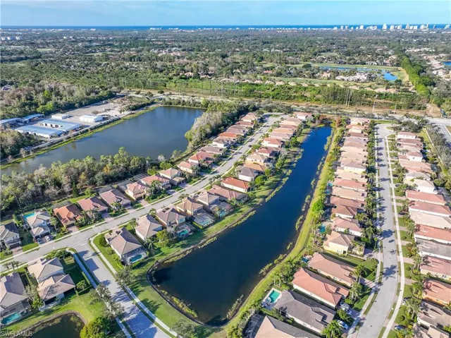 Birds eye view of property with a water view