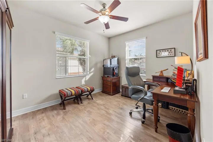 Office with ceiling fan and light hardwood / wood-style flooring