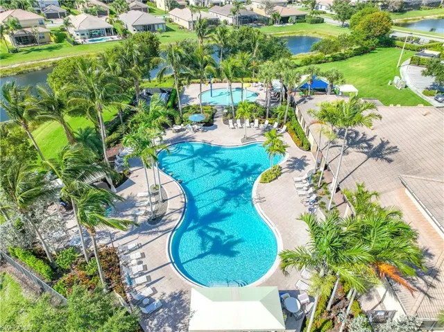 View of swimming pool with a water view and a patio area