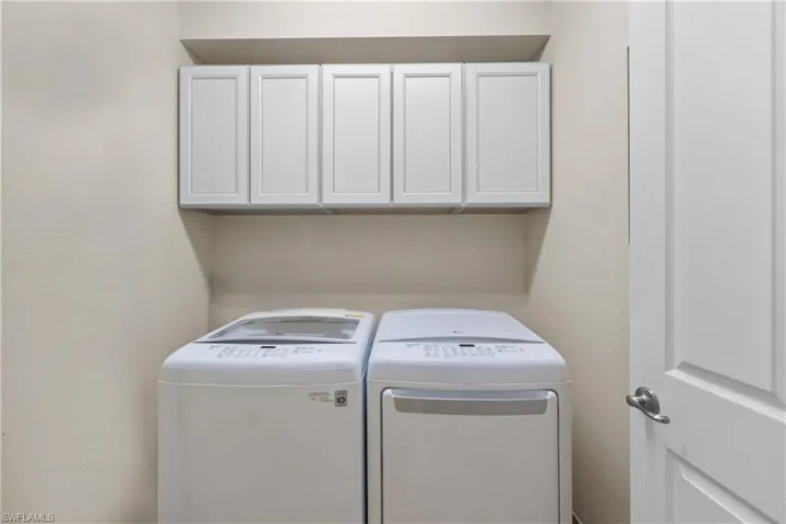 Clothes washing area with washing machine and dryer and cabinets