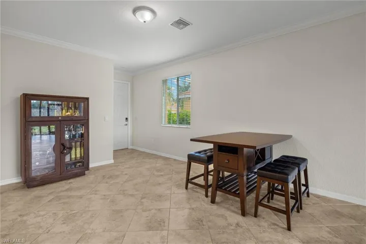 Tiled dining room with crown molding
