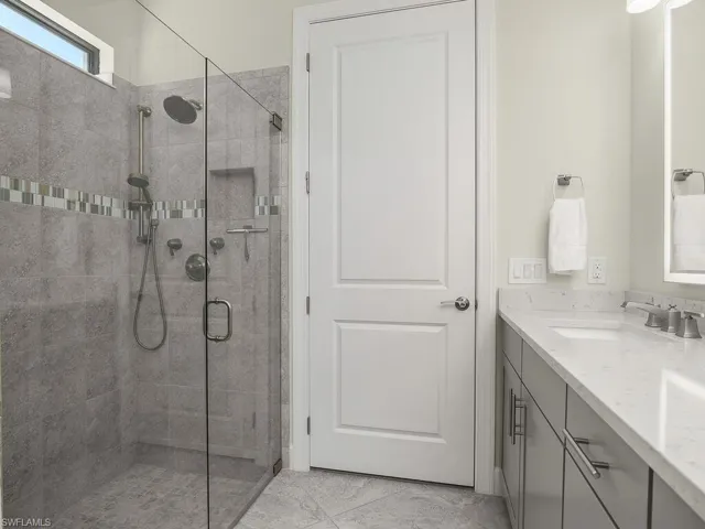 Walk-in shower with frameless glass.