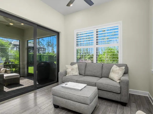 Sun room with sliders leading to screened outdoor lanai.