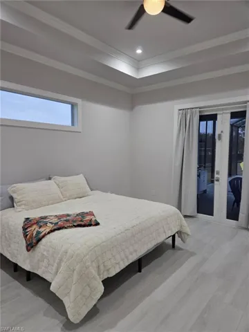 Bedroom featuring french doors, access to outside, recessed lighting, a ceiling fan, and light wood-style flooring
