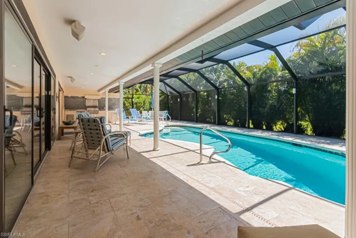 Outdoor pool with a patio area and a lanai