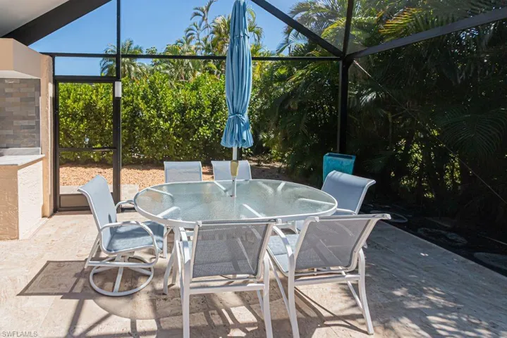 View of patio featuring glass enclosure and outdoor dining area