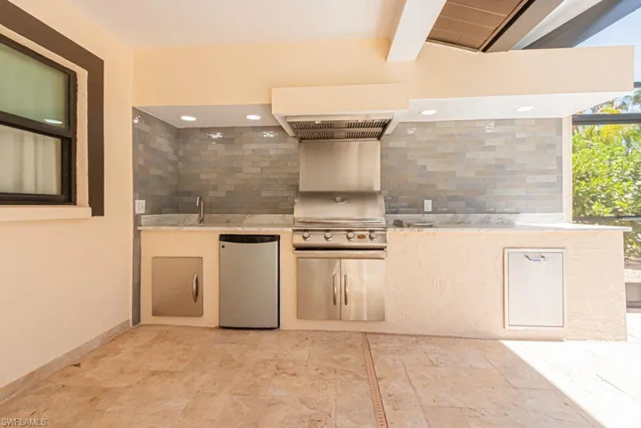 View of patio featuring grilling area, a sink, and an outdoor kitchen