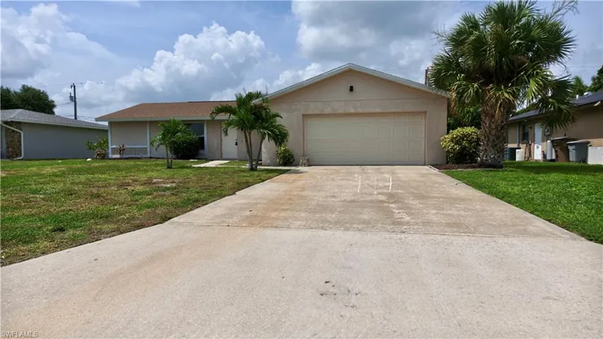 Single-story residence featuring a stucco exterior, attached two-car garage, and a concrete driveway