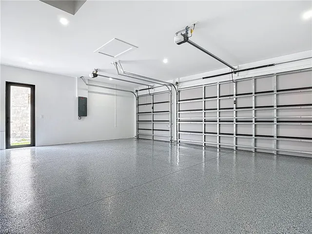 Garage with electric panel and a garage door opener