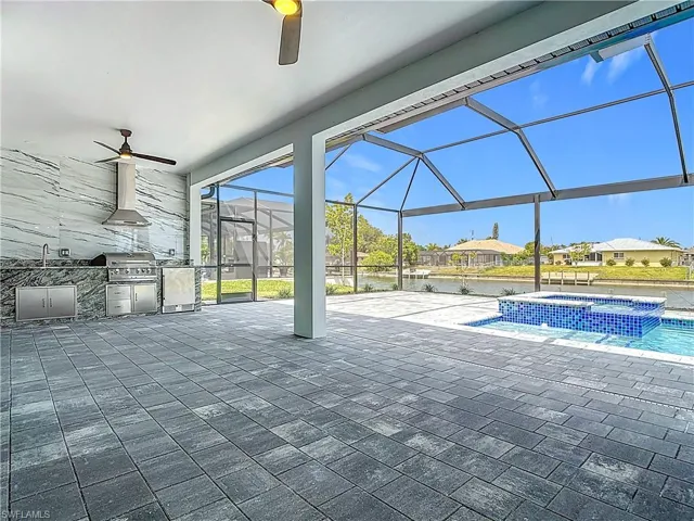View of pool with a patio area, a lanai, area for grilling, and ceiling fan