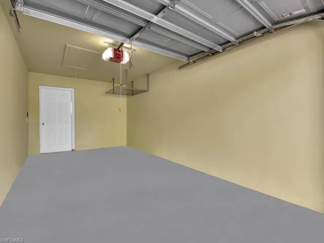 Garage featuring a garage door opener