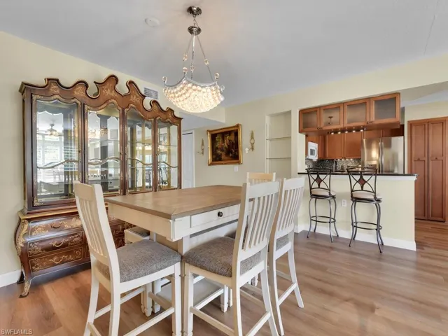 Dining space featuring a chandelier, light wood-type flooring, and baseboards