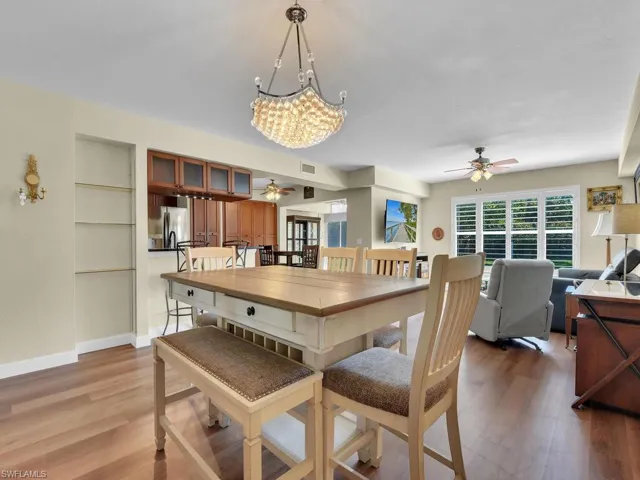 Dining room featuring light wood-type flooring, baseboards, visible vents, and a ceiling fan