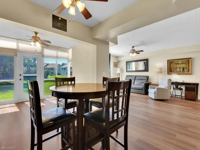 Dining space with ceiling fan and wood finished floors