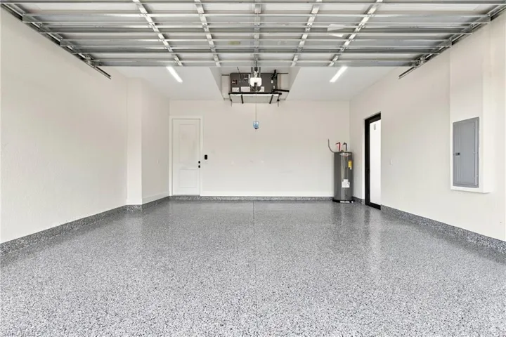 Spacious garage with an epoxy floor finish and white painted walls